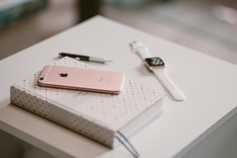 an iPhone on top of a book.